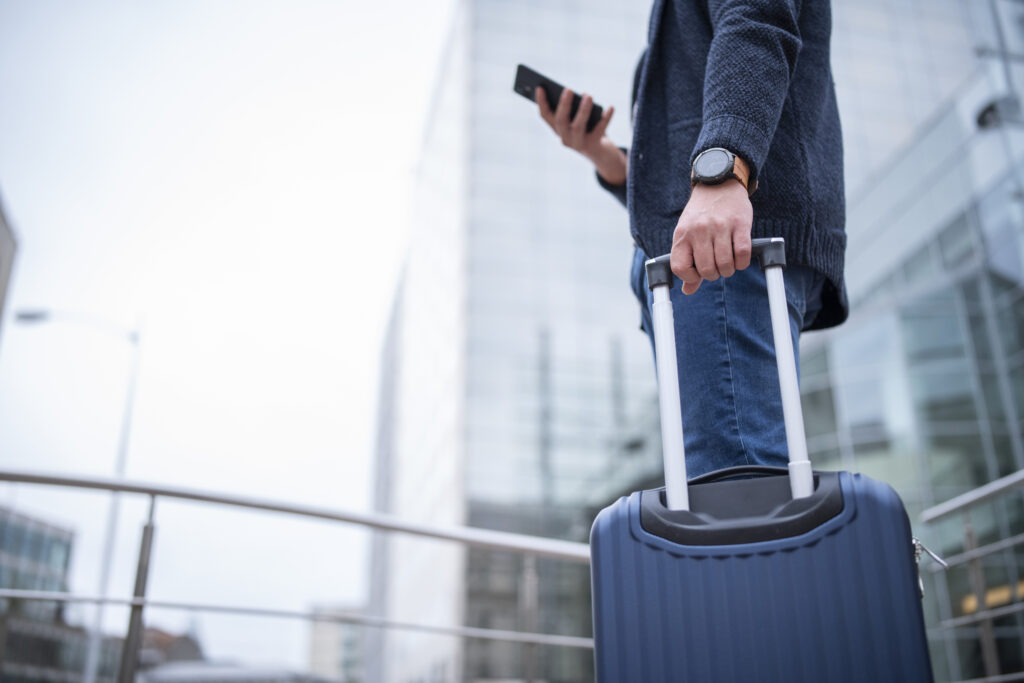 Close up of  a man standing with his luggage 
